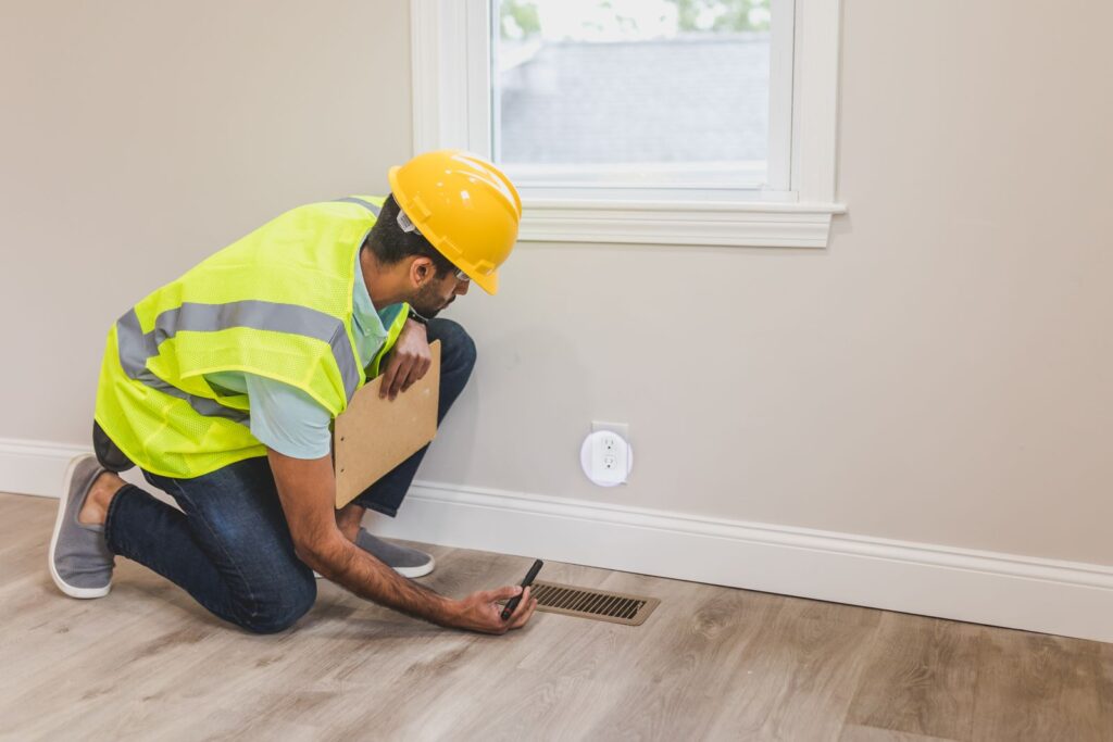 Inspecting a floor vent inside a home